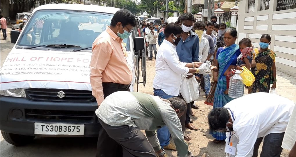 Volunteers distributing rations to the needy.